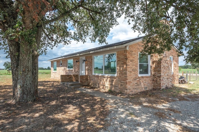 single story home with brick siding and crawl space