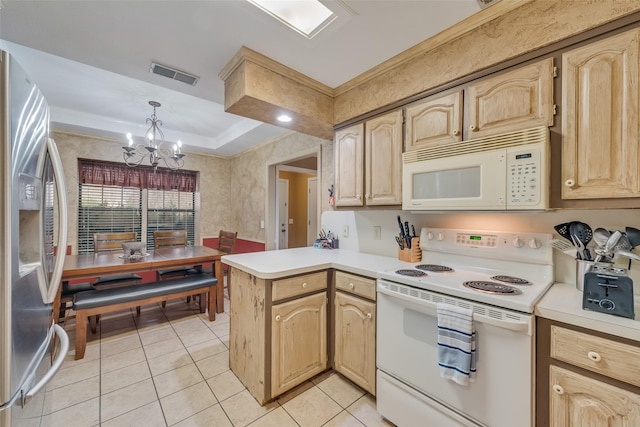 kitchen with light countertops, white appliances, visible vents, and a peninsula