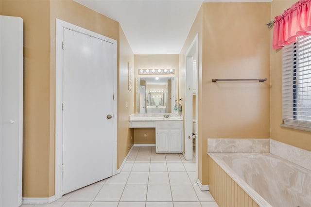 full bath with tile patterned flooring, a garden tub, vanity, and baseboards