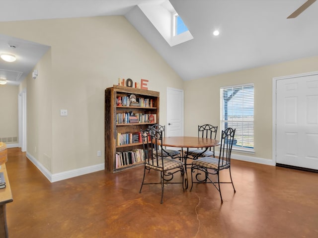 dining room featuring concrete flooring, high vaulted ceiling, visible vents, and baseboards