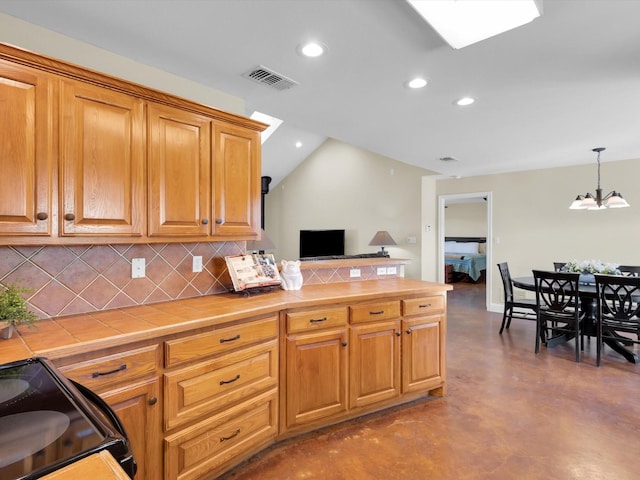 kitchen with visible vents, tile countertops, an inviting chandelier, concrete flooring, and black electric range