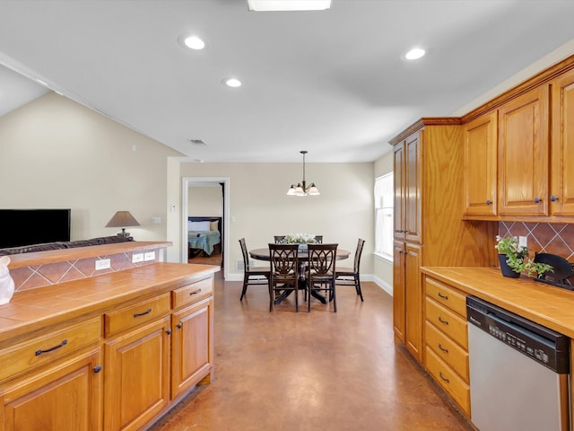 kitchen with tile counters, concrete flooring, dishwasher, and backsplash