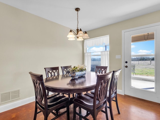 dining space featuring baseboards, concrete flooring, visible vents, and an inviting chandelier