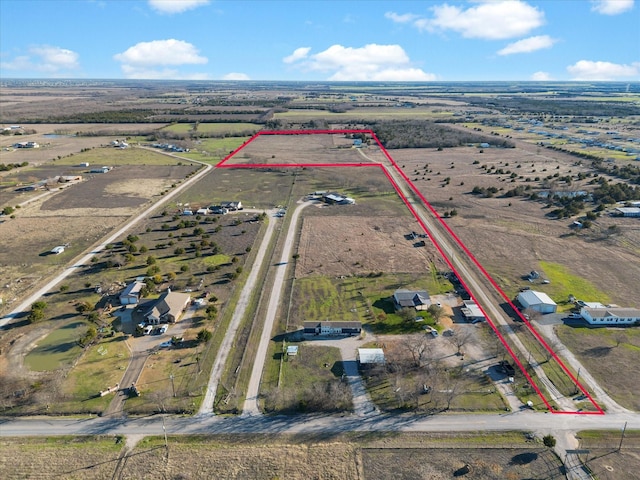 birds eye view of property with a rural view