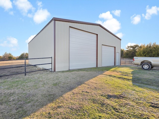 detached garage featuring fence