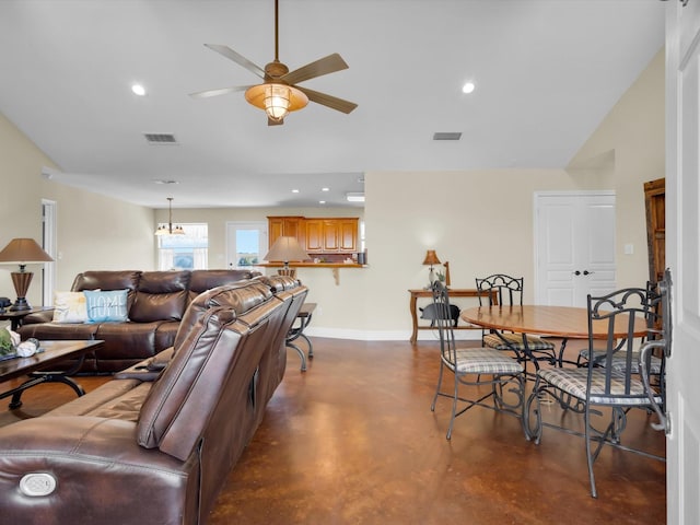 living area featuring lofted ceiling, baseboards, finished concrete floors, and visible vents