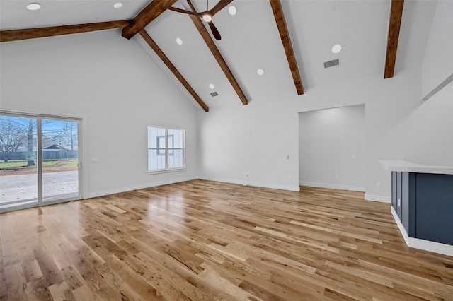 unfurnished living room with light wood-style floors, baseboards, high vaulted ceiling, and beamed ceiling