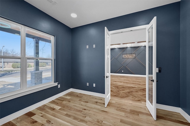 empty room with parquet flooring and baseboards