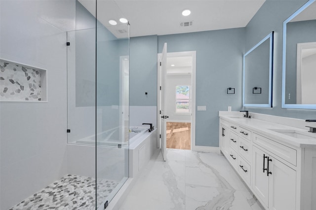 full bath featuring double vanity, visible vents, a sink, marble finish floor, and a bath