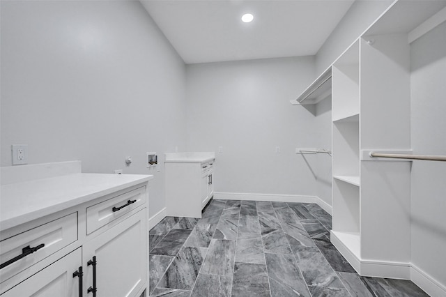 laundry room featuring washer hookup, cabinet space, baseboards, and recessed lighting