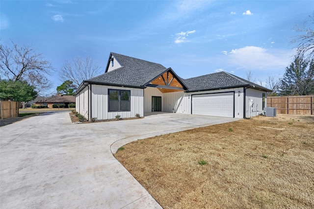 modern inspired farmhouse featuring driveway, a garage, central AC unit, roof with shingles, and fence