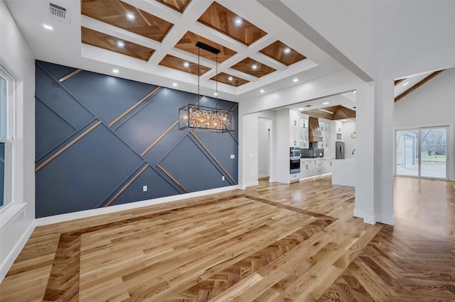 interior space with recessed lighting, visible vents, coffered ceiling, beamed ceiling, and parquet flooring