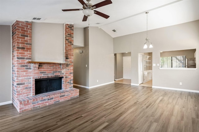 unfurnished living room with a fireplace, visible vents, wood finished floors, baseboards, and ceiling fan with notable chandelier