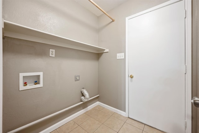 laundry area featuring light tile patterned flooring, hookup for an electric dryer, laundry area, washer hookup, and baseboards