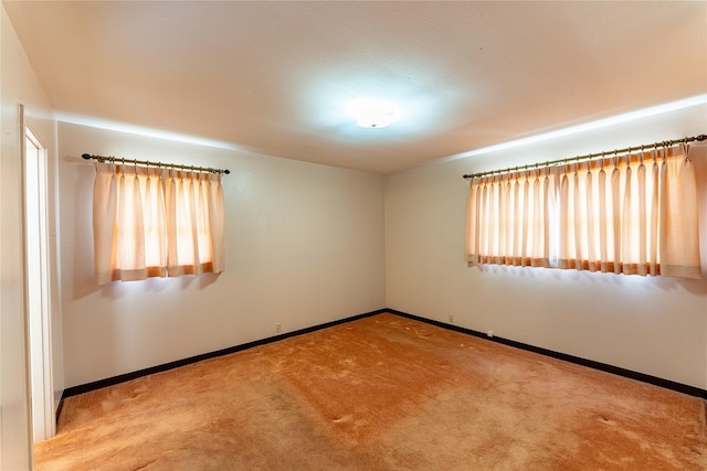 empty room with carpet floors and baseboards