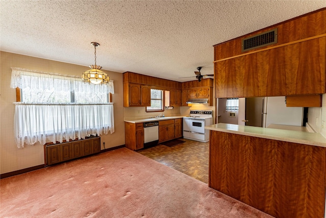 kitchen featuring white appliances, visible vents, brown cabinets, light countertops, and a textured ceiling