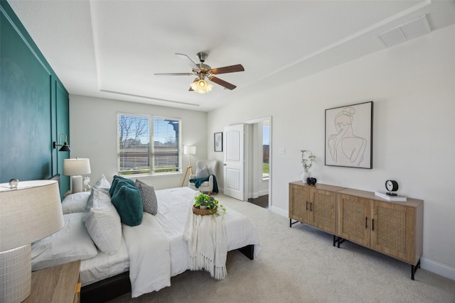 bedroom featuring light carpet, visible vents, baseboards, and a ceiling fan