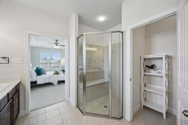 ensuite bathroom with a stall shower, connected bathroom, vanity, and tile patterned floors