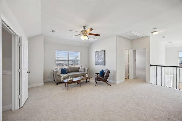 carpeted living room with a ceiling fan, lofted ceiling, visible vents, and baseboards