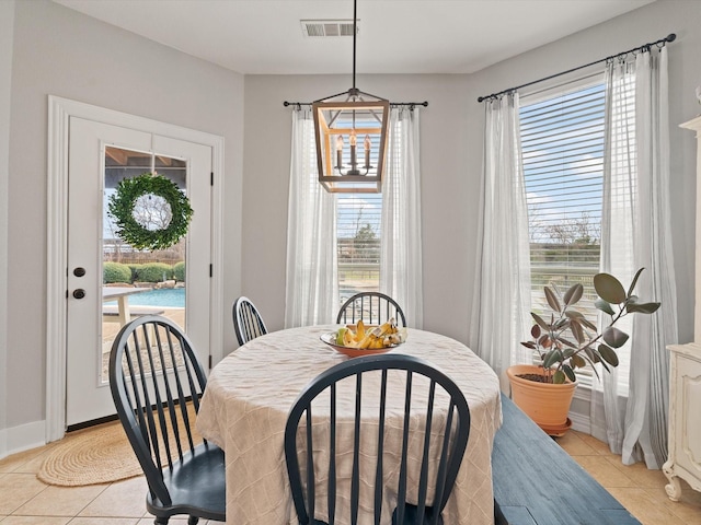 dining room with light tile patterned floors, baseboards, and visible vents