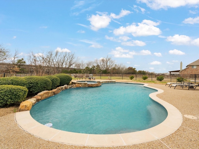 view of pool featuring a pool with connected hot tub, a patio area, and fence