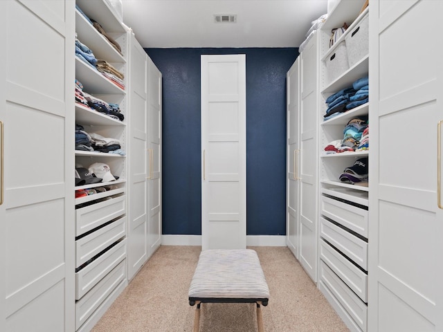 spacious closet featuring light carpet and visible vents