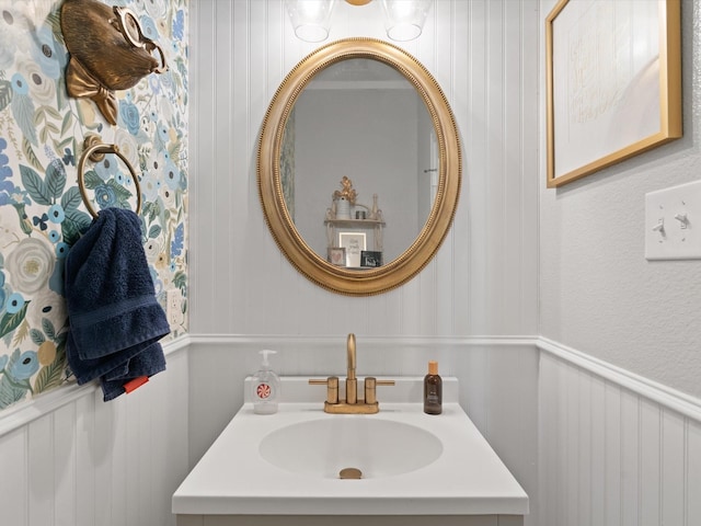 bathroom featuring a wainscoted wall and vanity