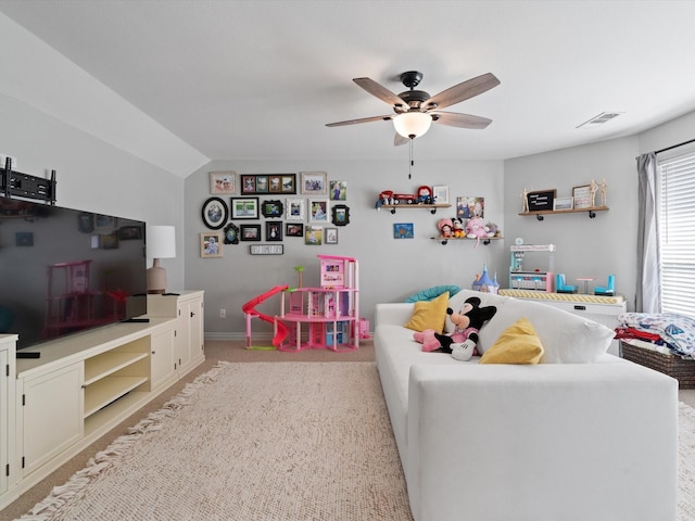 recreation room featuring a ceiling fan, lofted ceiling, visible vents, and light carpet