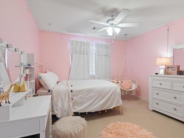 bedroom featuring light colored carpet, ceiling fan, and baseboards