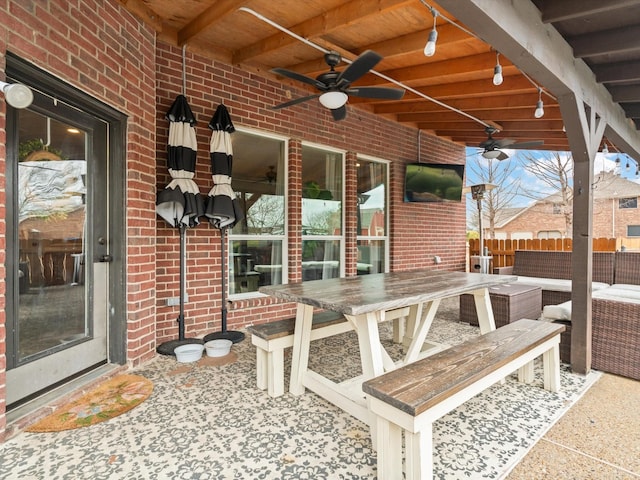 view of patio / terrace with fence and a ceiling fan