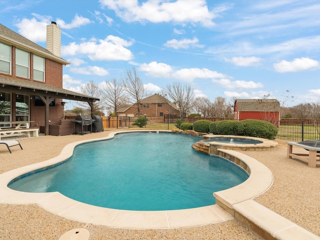 view of pool featuring a pool with connected hot tub, a fenced backyard, a patio, and area for grilling