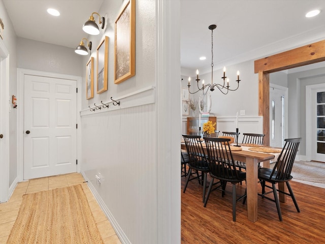 tiled dining room featuring a chandelier and recessed lighting