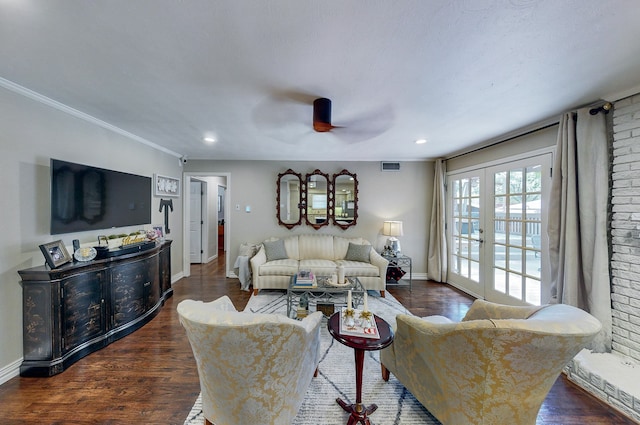 living area with french doors, visible vents, dark wood-type flooring, ornamental molding, and baseboards