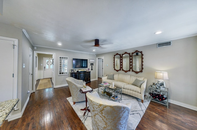 living area featuring crown molding, visible vents, a ceiling fan, wood finished floors, and baseboards