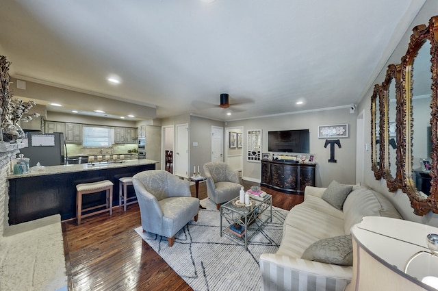 living room featuring ornamental molding, recessed lighting, and dark wood-style flooring