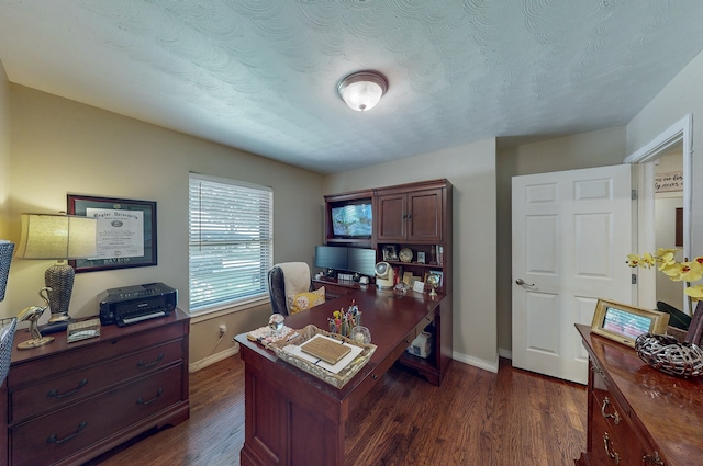 office space with a textured ceiling, dark wood-type flooring, and baseboards