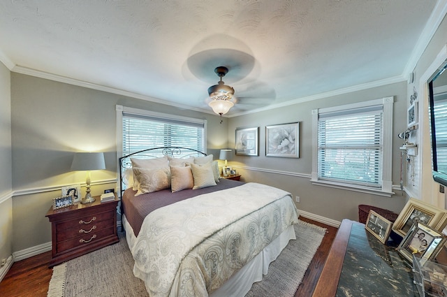 bedroom featuring ornamental molding, multiple windows, wood finished floors, and baseboards