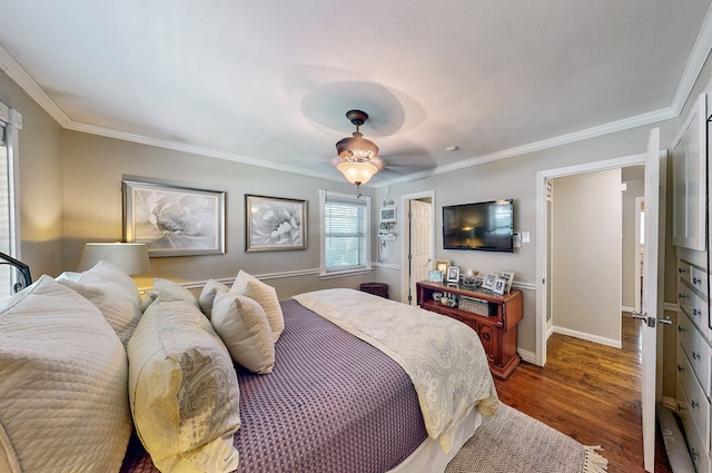 bedroom with crown molding, baseboards, and wood finished floors