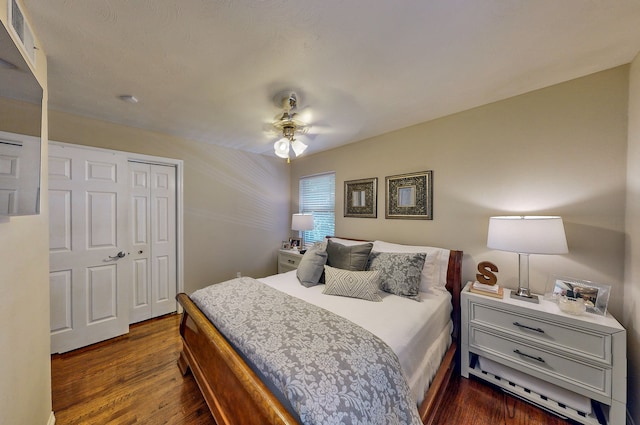 bedroom featuring a closet, wood finished floors, and a ceiling fan