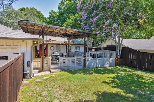 view of yard with fence, a wooden deck, and a pergola