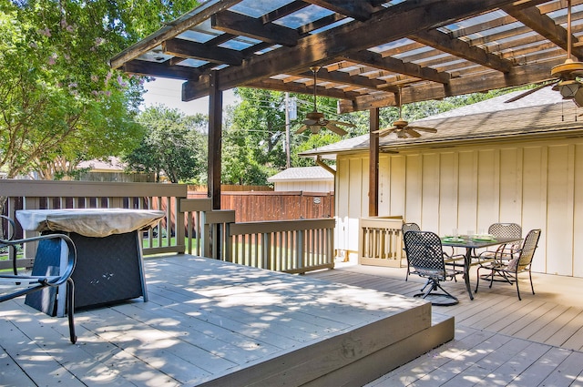 wooden deck featuring outdoor dining space, fence, and a pergola