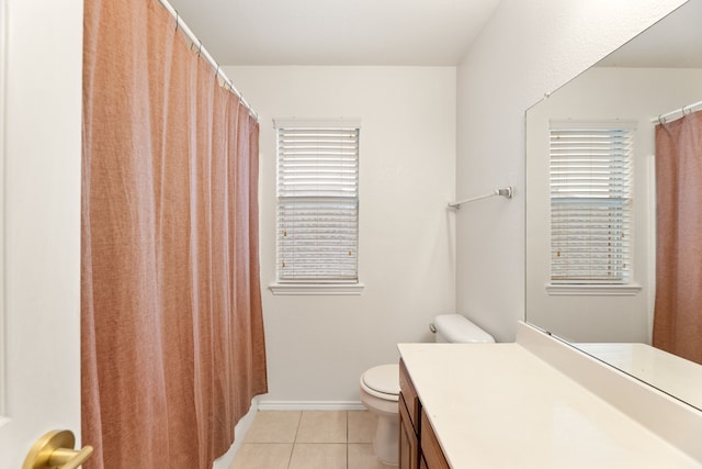 bathroom featuring baseboards, vanity, toilet, and tile patterned floors