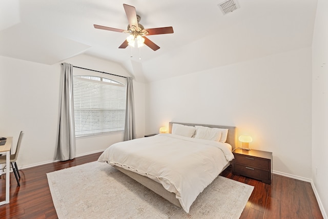 bedroom featuring lofted ceiling, dark wood-style floors, baseboards, and visible vents