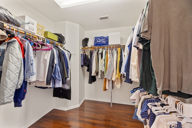 walk in closet featuring visible vents and wood finished floors