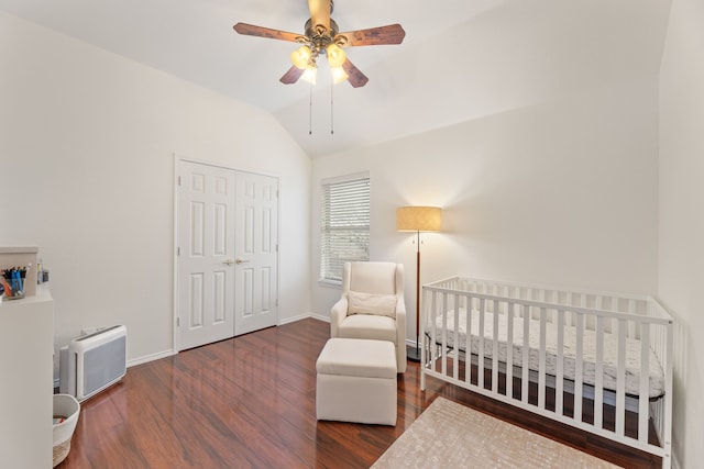 bedroom featuring lofted ceiling, a closet, baseboards, and wood finished floors