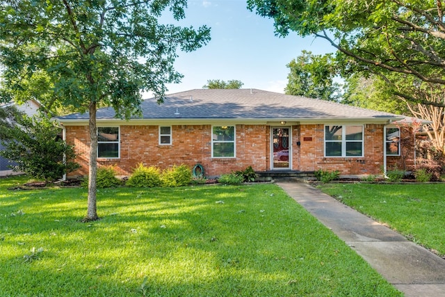 single story home with brick siding, roof with shingles, and a front yard