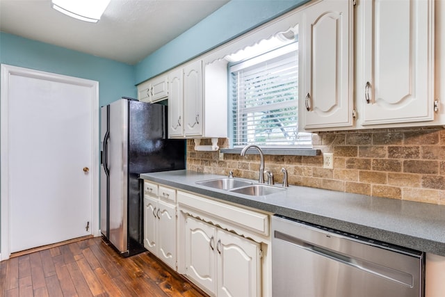 kitchen with tasteful backsplash, appliances with stainless steel finishes, dark wood-type flooring, white cabinetry, and a sink