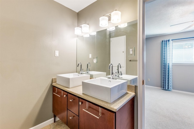 bathroom featuring baseboards and a sink