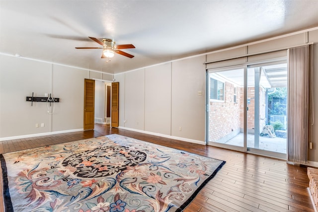 interior space featuring access to exterior, ceiling fan, baseboards, and wood finished floors