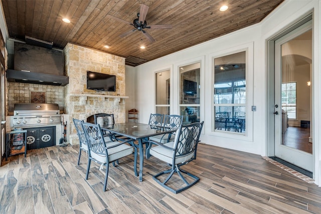 dining room with arched walkways, recessed lighting, wood finish floors, a fireplace, and wood ceiling